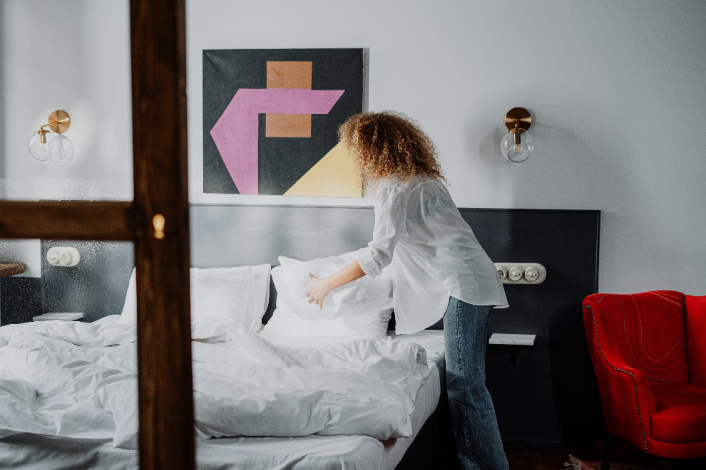 Woman organizing her bed space